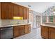 Classic kitchen featuring stainless steel appliances, wood cabinets, and a view into the sunny breakfast nook at 10625 Haynes Forest Dr, Alpharetta, GA 30022
