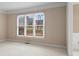 Living room bathed in natural light from large windows, offering a serene view at 10625 Haynes Forest Dr, Alpharetta, GA 30022
