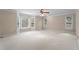 Spacious, sunlit room with many windows and a ceiling fan at 10625 Haynes Forest Dr, Alpharetta, GA 30022
