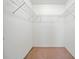 A standard walk-in closet with basic white wire shelving and tan carpet at 2160 Carefree Cir # 9, Marietta, GA 30062