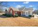 Charming brick home featuring a well-manicured lawn and lush landscaping, creating inviting curb appeal at 2160 Carefree Cir # 9, Marietta, GA 30062