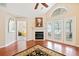 Open living space featuring a fireplace, access to the sunroom, and warm wood floors at 2160 Carefree Cir # 9, Marietta, GA 30062