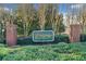 Entrance sign for 'The Crossings at East Cobb' in front of greenery and trees at 2160 Carefree Cir # 9, Marietta, GA 30062