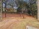 Backyard featuring a sloped lot, mature trees, and privacy fence at 2208 Howell Farms Nw Pt, Acworth, GA 30101