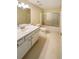 Standard bathroom with combination tub and shower, updated lighting, and white vanity at 2208 Howell Farms Nw Pt, Acworth, GA 30101