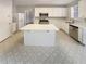 Well-lit eat-in kitchen boasting stainless steel appliances, white cabinetry, and a functional kitchen island at 2208 Howell Farms Nw Pt, Acworth, GA 30101