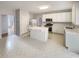 Bright eat-in kitchen with white cabinetry, stainless steel appliances, and a center island for ample workspace at 2208 Howell Farms Nw Pt, Acworth, GA 30101
