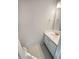 Simple, clean powder room with a white vanity, sink, and a large mirror at 2208 Howell Farms Nw Pt, Acworth, GA 30101