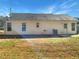 Back of home with green lawn, side door and windows at 338 Thorn Thicket Dr, Rockmart, GA 30153