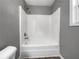 Bathroom features a tub and shower combination with wood-look floors at 338 Thorn Thicket Dr, Rockmart, GA 30153