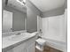 Bathroom with white vanity, toilet, tub, and gray walls at 338 Thorn Thicket Dr, Rockmart, GA 30153
