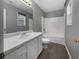 Clean bathroom featuring a white vanity, tub/shower combination, and wood-look flooring at 338 Thorn Thicket Dr, Rockmart, GA 30153