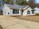 Charming home with a concrete driveway and lush green lawn at 338 Thorn Thicket Dr, Rockmart, GA 30153