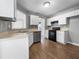 Efficient kitchen with white cabinets, black appliances, and durable wood-look flooring at 338 Thorn Thicket Dr, Rockmart, GA 30153