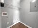 View of laundry room with wire shelf, hookups, and flooring at 338 Thorn Thicket Dr, Rockmart, GA 30153