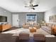 Bright, staged living room features hardwood floors and comfortable seating arrangement under a ceiling fan at 338 Thorn Thicket Dr, Rockmart, GA 30153