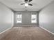 Neutral main bedroom featuring carpet, neutral walls, and two windows at 338 Thorn Thicket Dr, Rockmart, GA 30153
