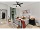 Stylish bedroom featuring a large window, modern ceiling fan, and decorative wall art at 2626 Peachtree Nw Rd # 206, Atlanta, GA 30305