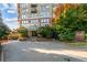 Apartment building entrance with a glass awning, landscaped surroundings, and convenient driveway at 2626 Peachtree Nw Rd # 206, Atlanta, GA 30305