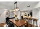 Open dining area featuring wooden table, breakfast bar, pendant lights and modern decor at 2626 Peachtree Nw Rd # 206, Atlanta, GA 30305