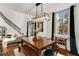 Dining room with dark wooden table, pendant lighting, large window and staircase at 2626 Peachtree Nw Rd # 206, Atlanta, GA 30305