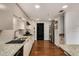 Modern kitchen with granite countertops, stainless steel appliances, and dark-stained hardwood floors at 2626 Peachtree Nw Rd # 206, Atlanta, GA 30305