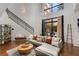 Bright living room featuring a soaring ceiling, hardwood floors and access to an outdoor patio at 2626 Peachtree Nw Rd # 206, Atlanta, GA 30305