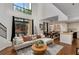 Open concept living space featuring hardwood floors, soaring windows, and modern furnishings at 2626 Peachtree Nw Rd # 206, Atlanta, GA 30305