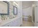 Elegant bathroom with double vanities, floral wallpaper, soaking tub, and a glass-enclosed shower for a spa-like experience at 325 E Paces Ferry Ne Rd # 2005, Atlanta, GA 30305