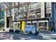 Storefront view featuring outdoor seating, a delivery truck, and an inviting entrance with a yellow curtain accent at 325 E Paces Ferry Ne Rd # 2005, Atlanta, GA 30305