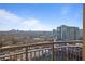 Balcony view featuring a cityscape and trees against a bright, partly cloudy sky at 325 E Paces Ferry Ne Rd # 2005, Atlanta, GA 30305