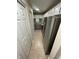 A well-lit galley kitchen featuring stainless steel appliances and tile flooring at 4351 Timberlake, Stone Mountain, GA 30083