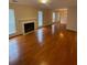 Open living room with fireplace, hardwood floors, and plenty of natural light through large windows at 4351 Timberlake, Stone Mountain, GA 30083