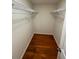 Organized walk-in closet with wire shelving and hardwood flooring at 4351 Timberlake, Stone Mountain, GA 30083