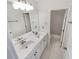 Bright bathroom featuring double sinks, large mirror, and a doorway to a shower and toilet room at 5025 Skipping Stone Ct, Cumming, GA 30028