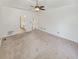 A large bedroom with a ceiling fan boasts a view of the bathroom at 5025 Skipping Stone Ct, Cumming, GA 30028