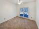 Bright bedroom featuring carpeted floors and a large window at 5025 Skipping Stone Ct, Cumming, GA 30028