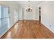 A dining room with hardwood floors, bright natural light, and classic chandelier creates an inviting space at 5025 Skipping Stone Ct, Cumming, GA 30028