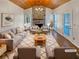 The staged living room features a stone fireplace, vaulted ceilings and stylish decor at 5025 Skipping Stone Ct, Cumming, GA 30028