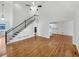 A living room with hardwood floors and a staircase has great natural light at 5025 Skipping Stone Ct, Cumming, GA 30028