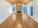 A fireplace is the focal point in this living room featuring wood-clad ceilings and hardwood floors at 5025 Skipping Stone Ct, Cumming, GA 30028