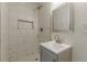 Well-lit bathroom featuring a tiled shower and modern vanity with sleek fixtures at 8483 Magnolia Dr, Jonesboro, GA 30238