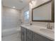 Beautifully remodeled bathroom featuring double sinks and a shower with white tile at 8483 Magnolia Dr, Jonesboro, GA 30238