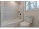 Bright bathroom showcasing tiled shower, and updated fixtures at 8483 Magnolia Dr, Jonesboro, GA 30238