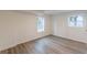 Sunlit bedroom showcases wood-look flooring and two bright windows at 8483 Magnolia Dr, Jonesboro, GA 30238