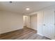 Bedroom featuring modern wood-look floors, white walls, and closet at 8483 Magnolia Dr, Jonesboro, GA 30238