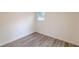 Simple bedroom with new flooring, neutral walls, and an exterior view at 8483 Magnolia Dr, Jonesboro, GA 30238