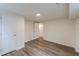 Bedroom featuring modern wood-look floors, white walls, and updated lighting at 8483 Magnolia Dr, Jonesboro, GA 30238