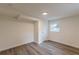 Bedroom featuring modern wood-look floors, white walls, and natural light from windows at 8483 Magnolia Dr, Jonesboro, GA 30238