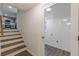 Hallway featuring stairs to the kitchen and a doorway to the laundry room at 8483 Magnolia Dr, Jonesboro, GA 30238